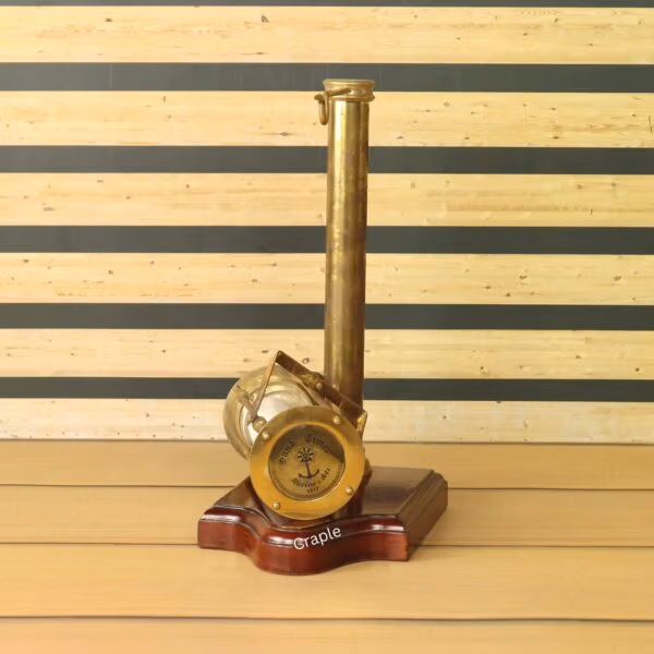 The side view of the wooden base, showing the integrated antique brass compass.