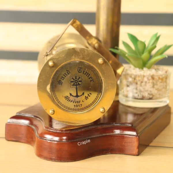 Close-up of the brass compass dial on the wooden base, featuring an anchor and "Grand Times Marine" text.