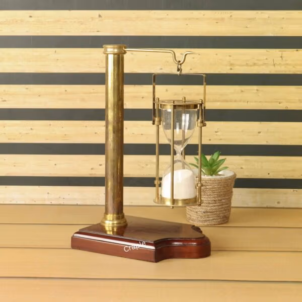 The hanging brass sand timer displayed as a sophisticated office or home decor accessory.