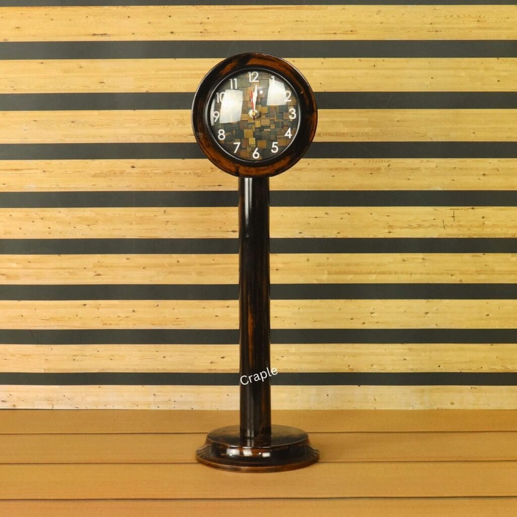 A tall handcrafted wooden pedestal clock with a brown-black antique finish and a round, uniquely patterned face.
