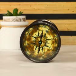 Close-up of the vintage-style compass integrated into the base of the antique brass hourglass.