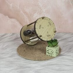 Angled top-down view of the rotating hourglass, showing the wooden top with engraved 2, 3, and 5-minute markers.