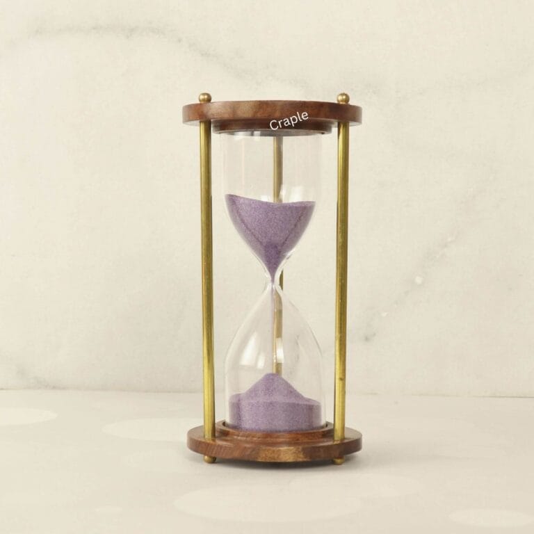 A vintage 5-minute hourglass with purple sand, framed by round wooden bases and elegant brass pillars.