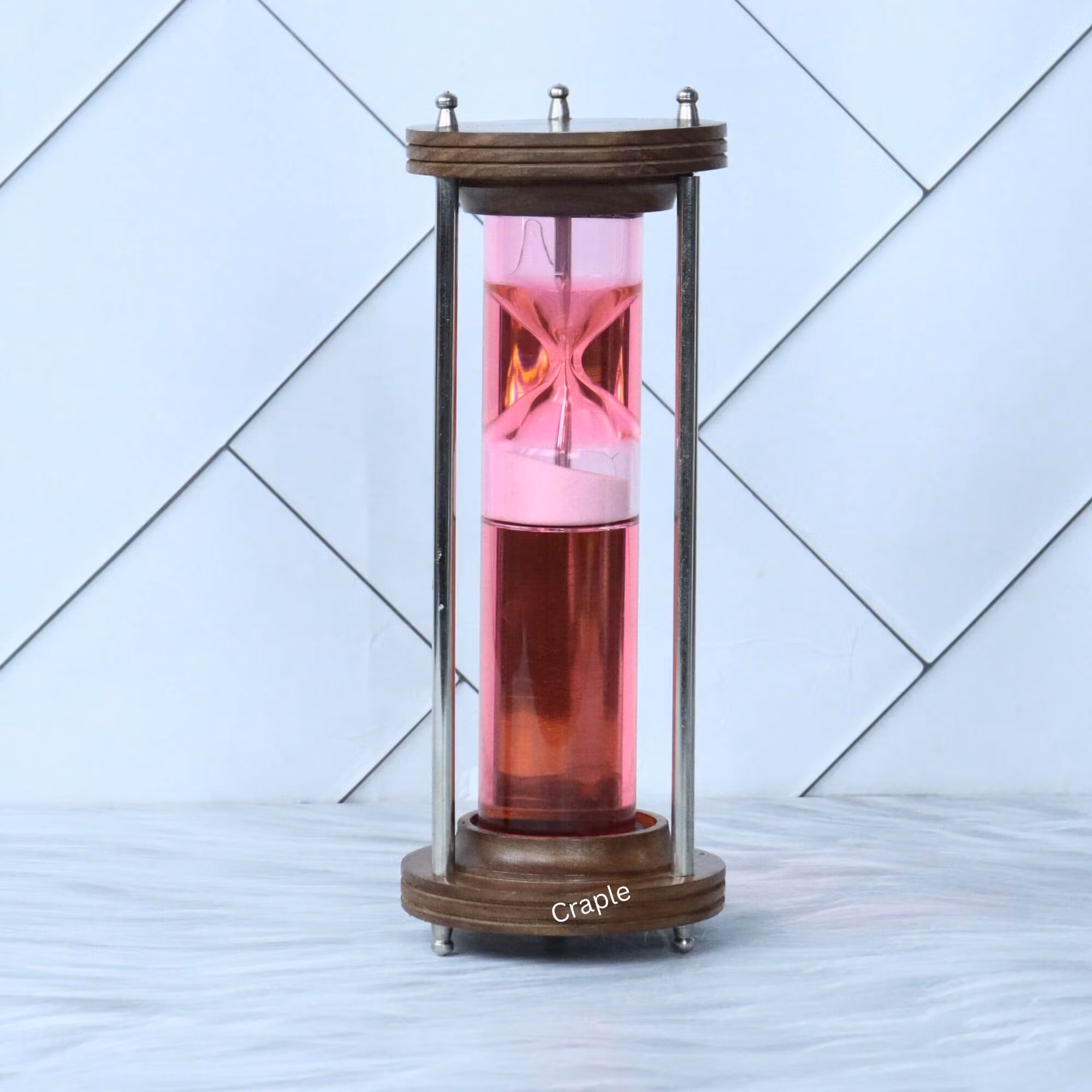 Wood Brass Liquid Hourglass-1 A modern liquid hourglass with a wood and brass frame, featuring a floating pink timer mechanism in red liquid.
