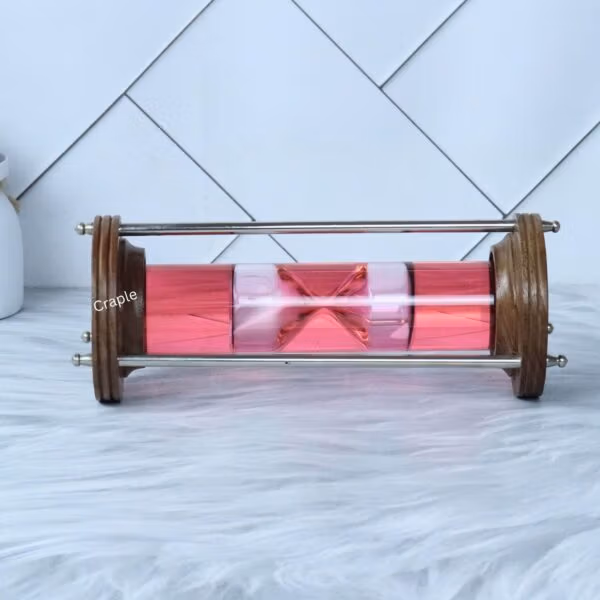 A straight-on horizontal view of the liquid hourglass, displaying the internal timer mechanism clearly.