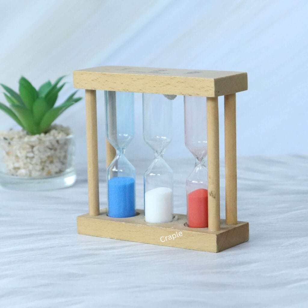 Handmade wooden triple sand timer with 1, 3, and 5-minute hourglasses, shown from an angle to highlight its natural wood construction.