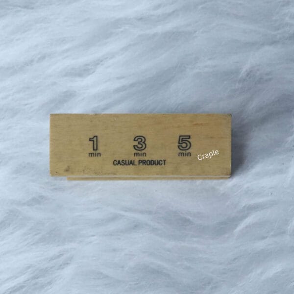 Top of the wooden sand timer showing the engraved 1, 3, and 5-minute markers.