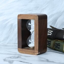 Angled view of the custom wooden sand timer, highlighting the smooth, handcrafted frame and rounded corners.