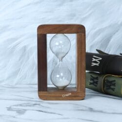 Low-angle view of the personalized hourglass, showing the white sand settled in the bottom of the glass.